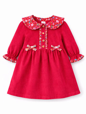 Red dress with floral collar and bow details on a white background