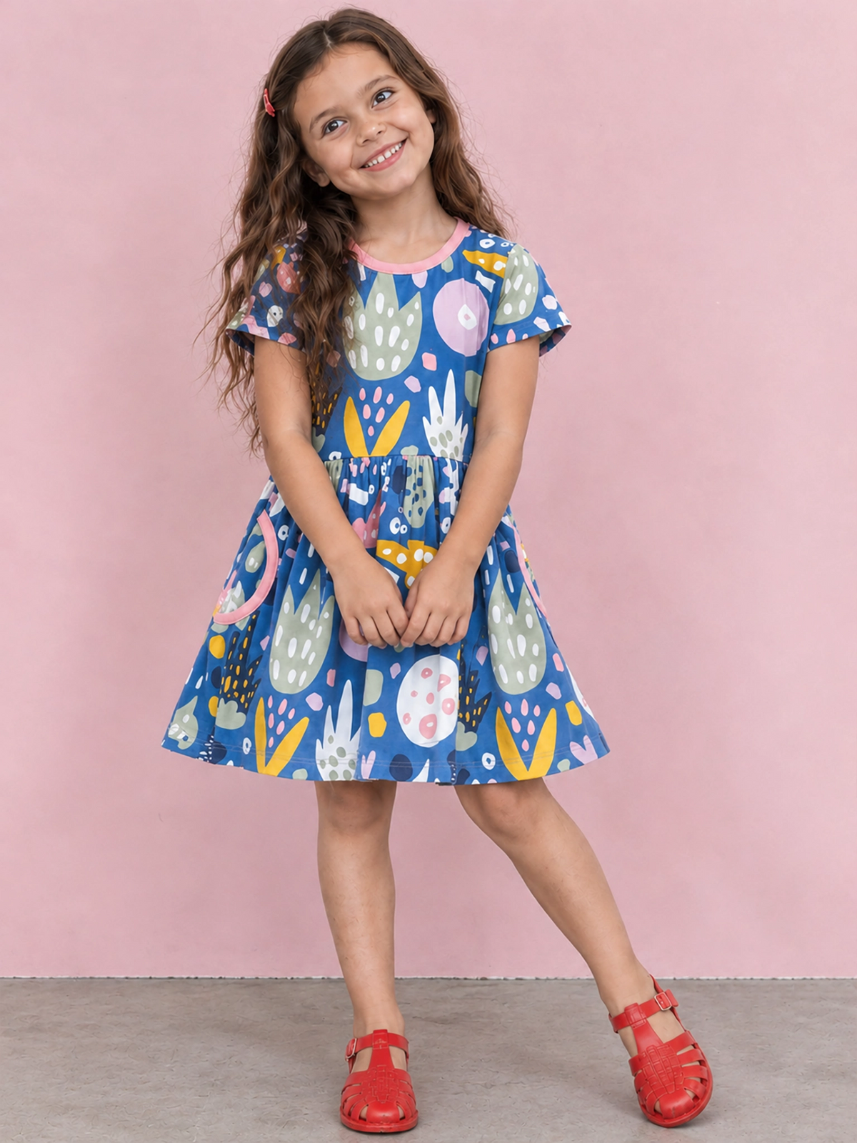 Girl in Navy Jungle Amelie skater dress and red sandals