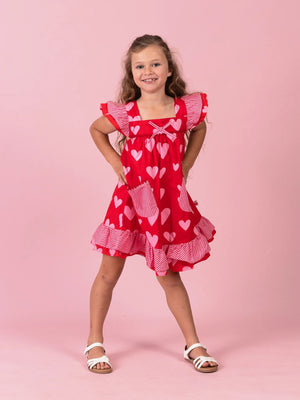 Smiling girl in the Big Red Heart Holly dress
