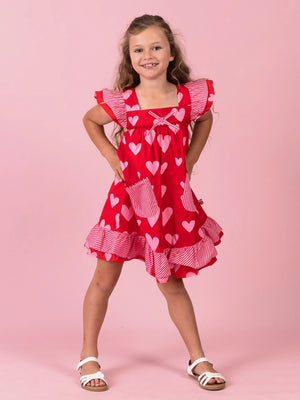 Smiling girl in the Big Red Heart Holly dress