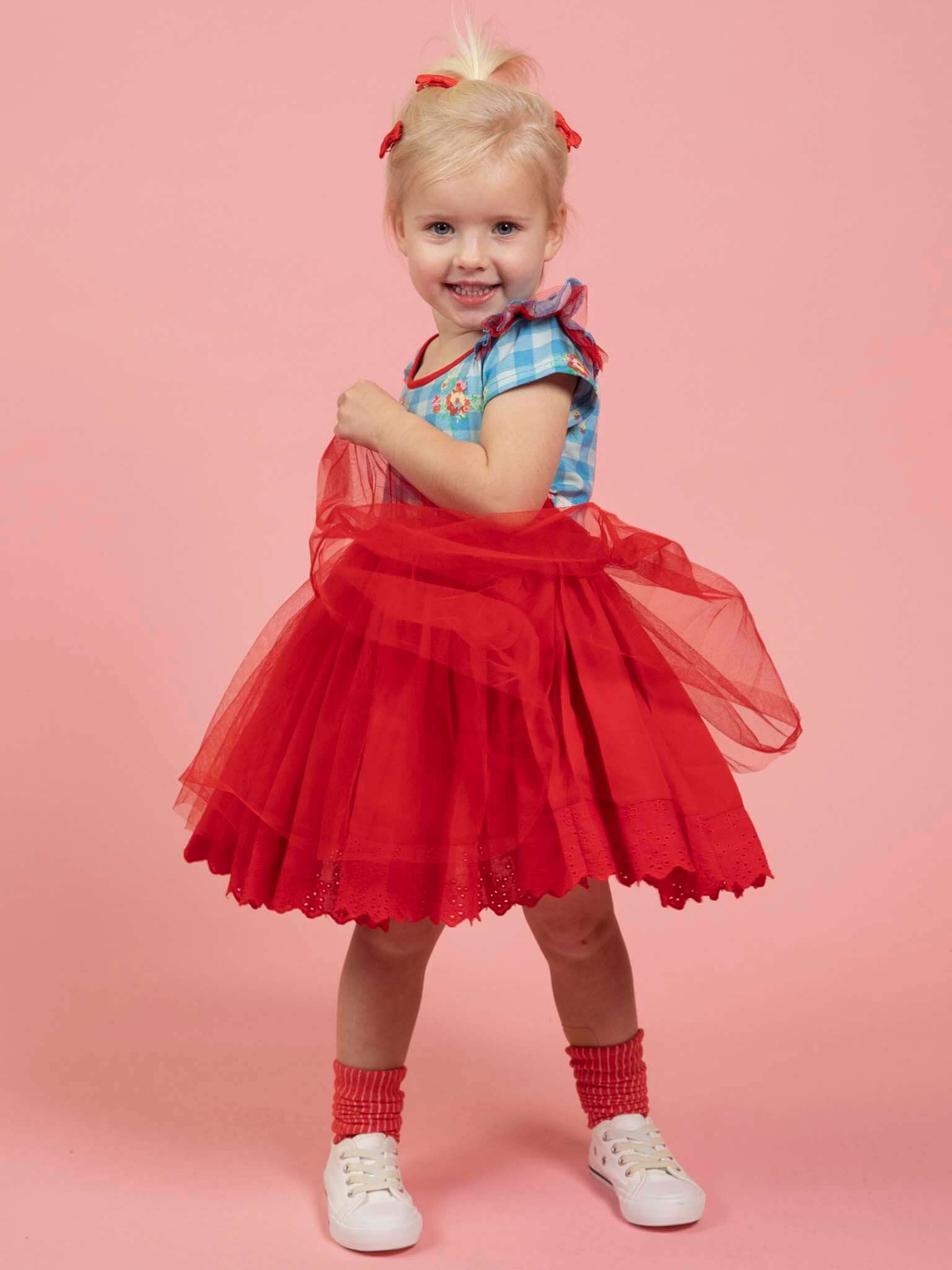 Child wearing a blue checkered gingham red tutu skirt dress