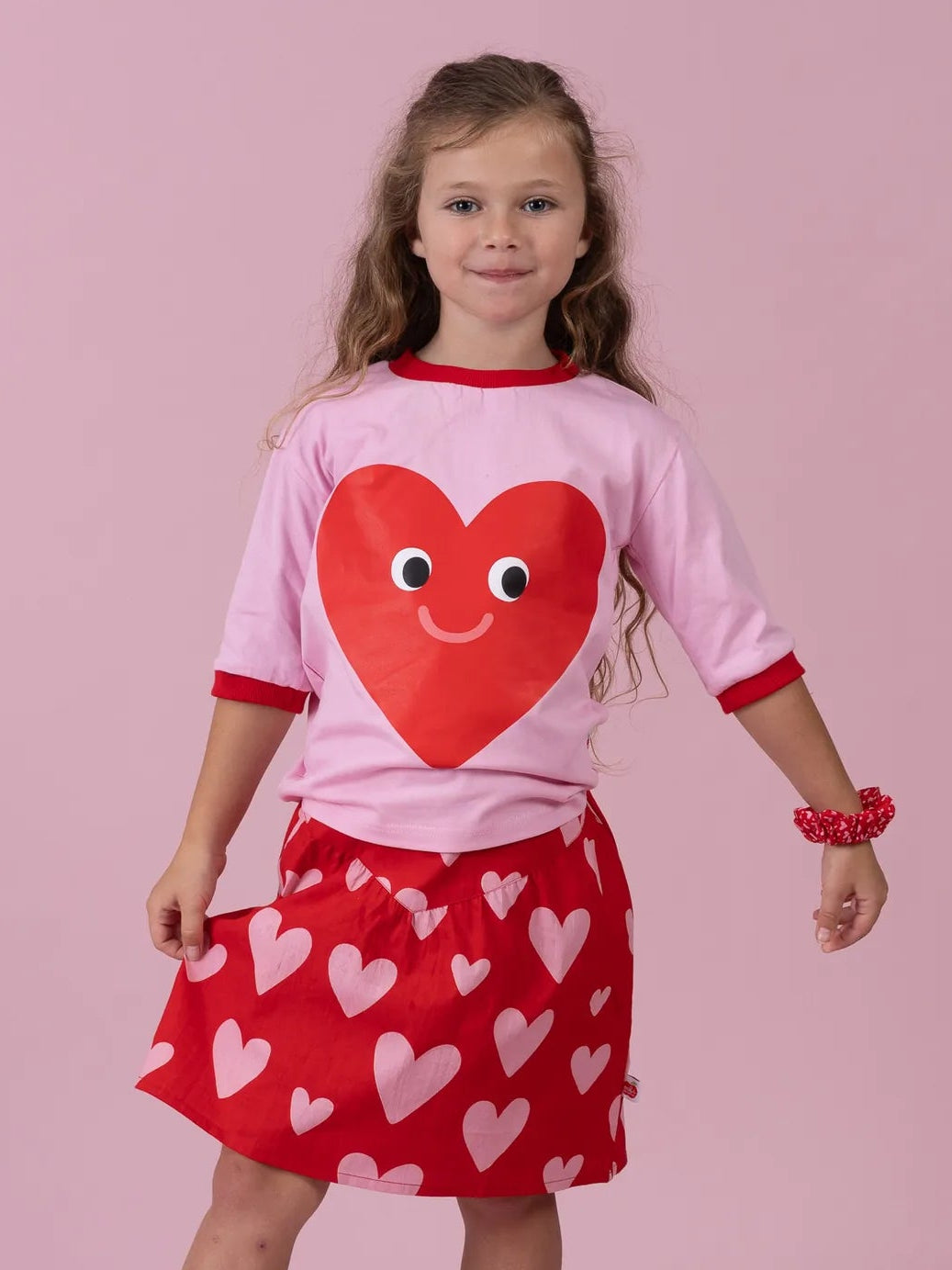 Girl in the pink Happy Heart tee and Big Red Heart yoke skirt