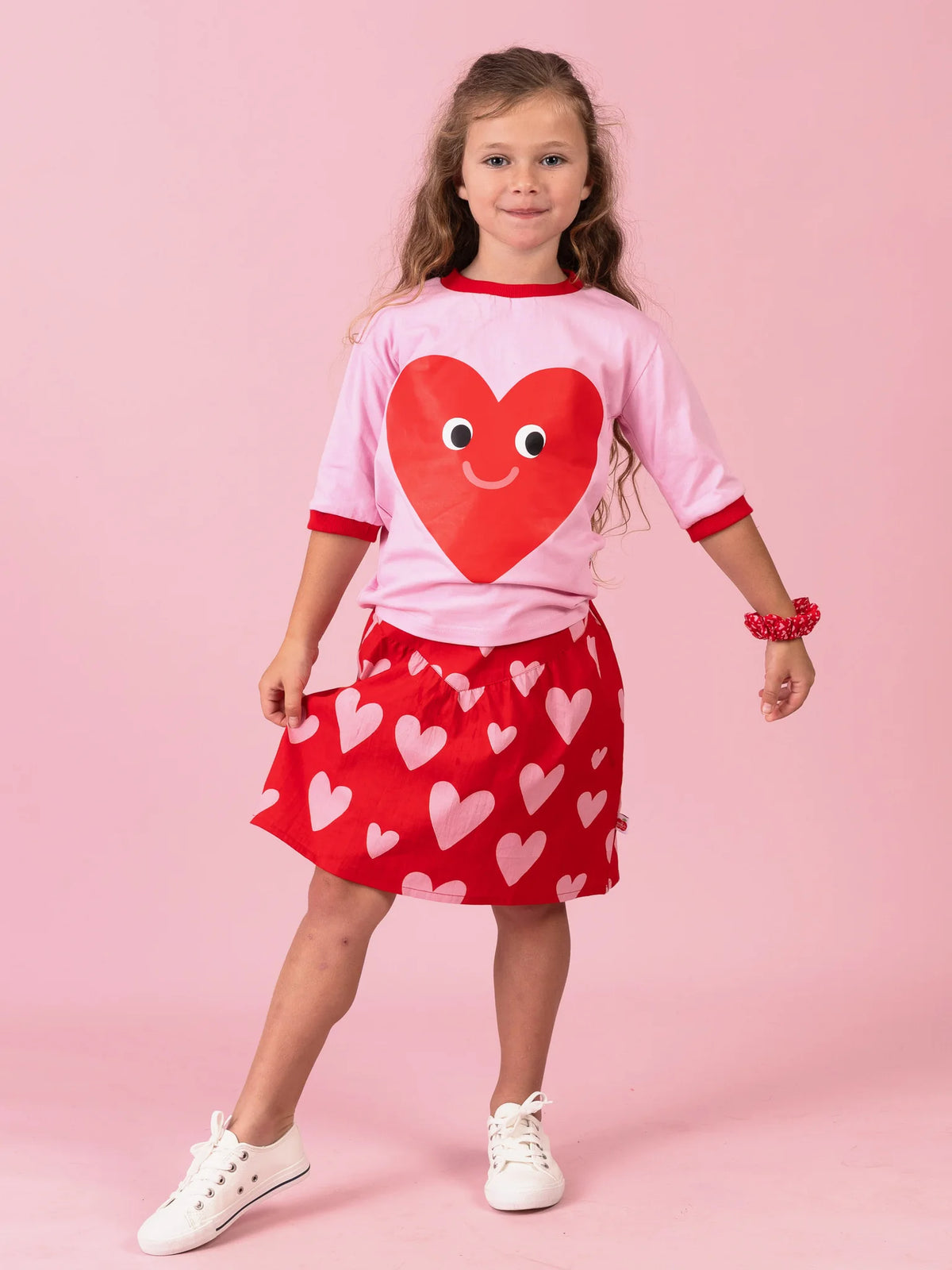 Girl in the pink Happy Heart tee and Big Red Heart yoke skirt