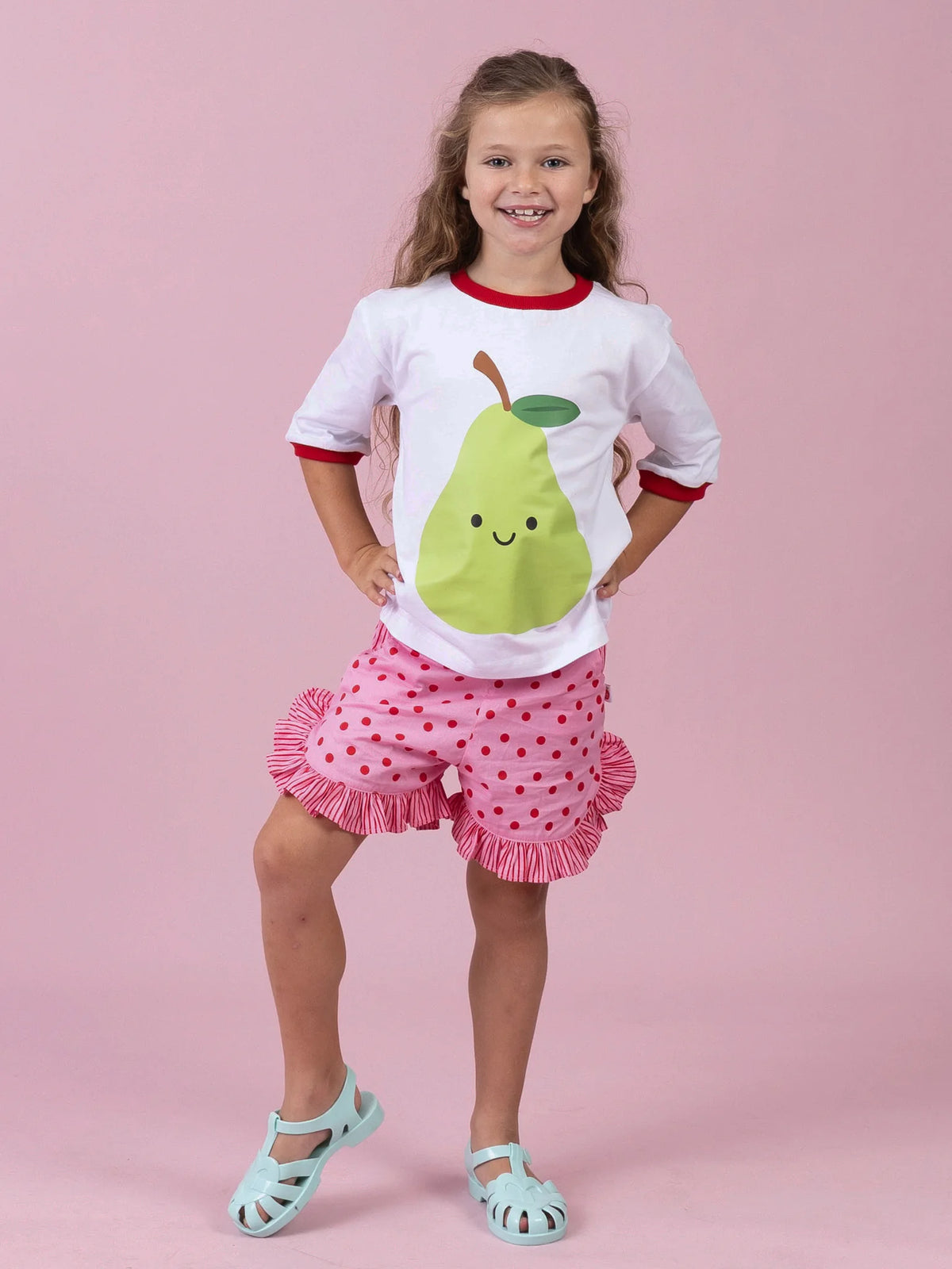 Girl in the white Happy Pear tee and Pink & Red Dots ruffle shorts