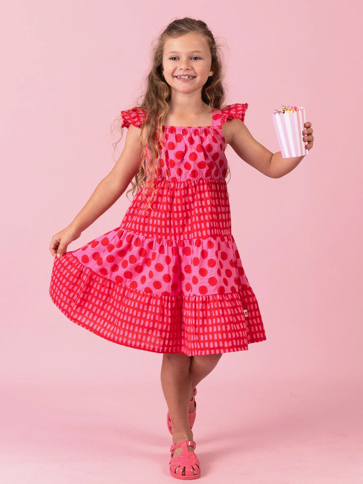 Girl dancing with one foot up in the Jaipur Block-Print Holiday dress