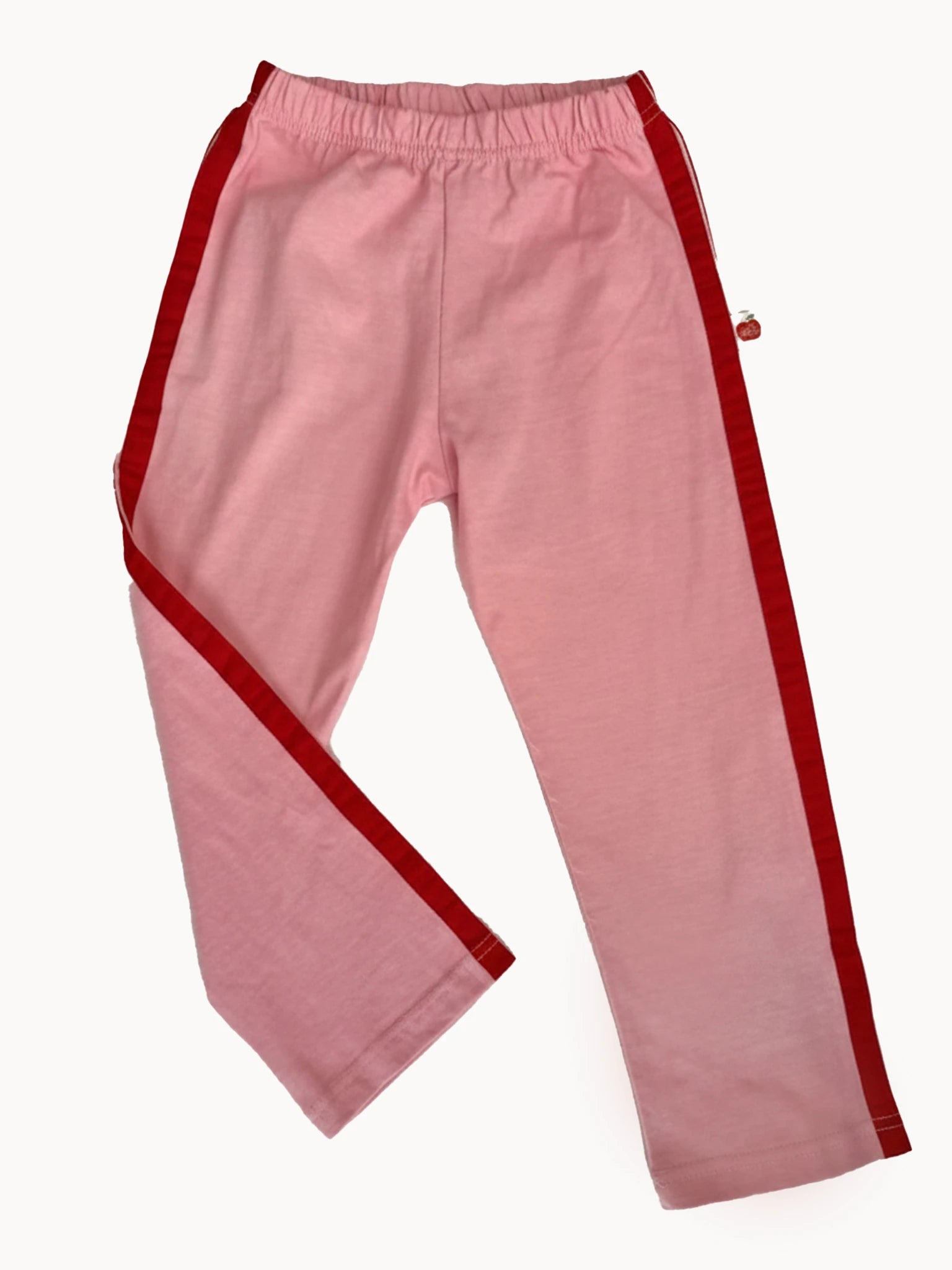 Essentials Pink Jersey 2 Stripe Pants for girls, featuring red side stripes, an elastic waistband, and straight legs, are displayed flat on a white background.