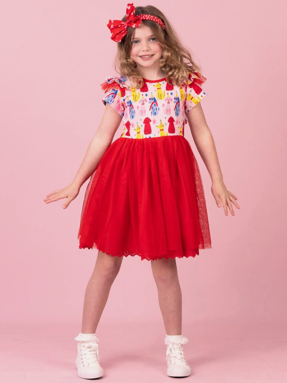 Girl in Party Pooches Claudia tutu dress with red tulle skirt and bow headband