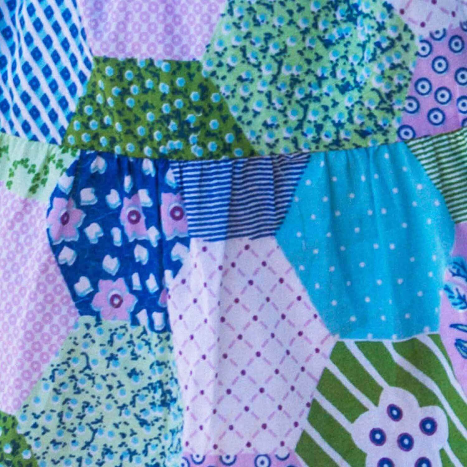 Patchwork fabric with various patterns and colors on a multicolored background