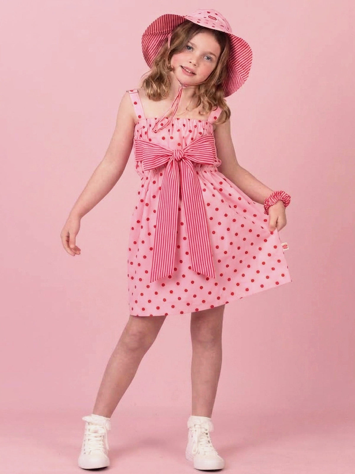 Girl in Marlow polka dot dress with oversized bow tied at the front
