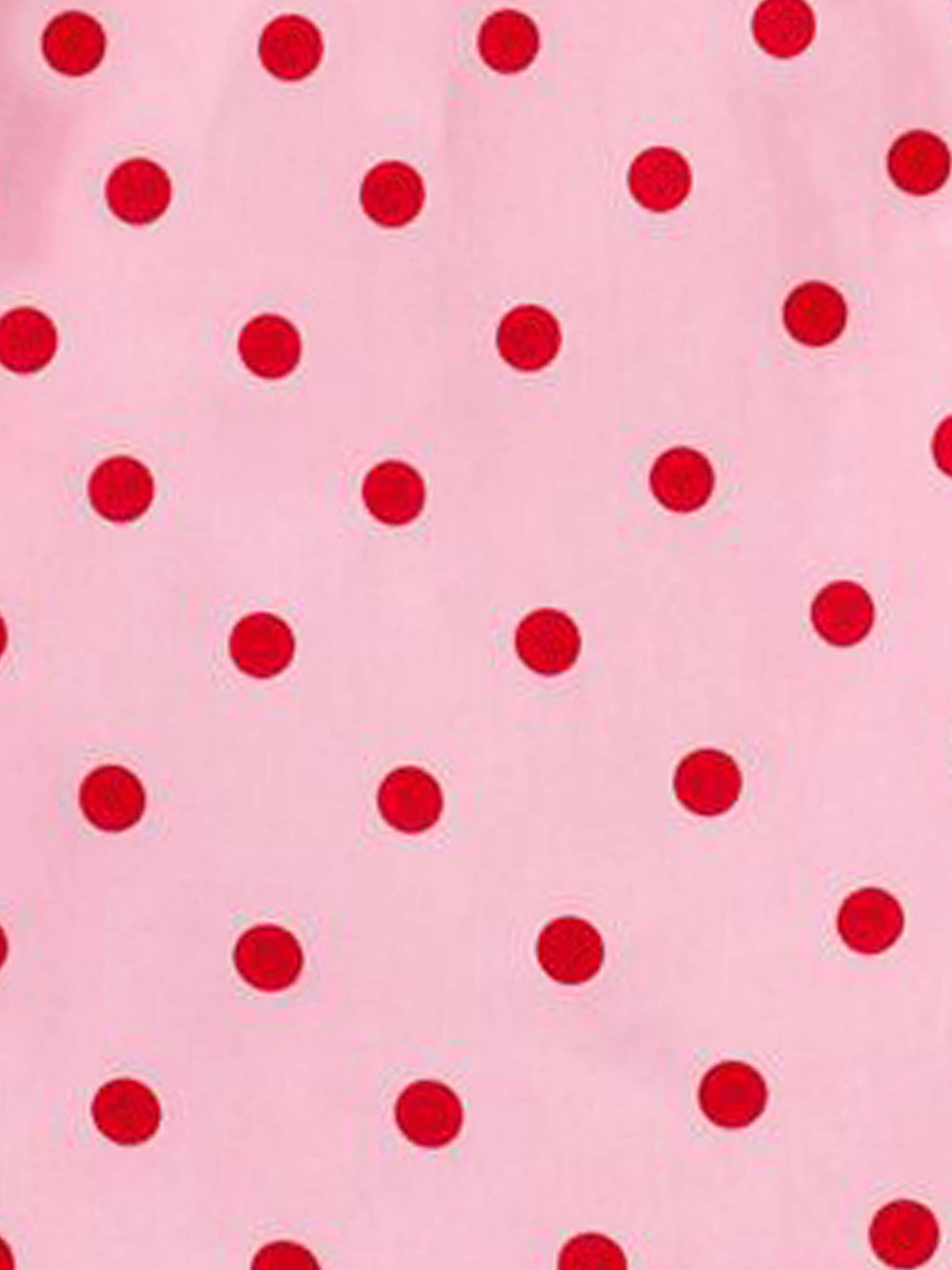 Pink fabric with a repeating pattern of red polka dots.