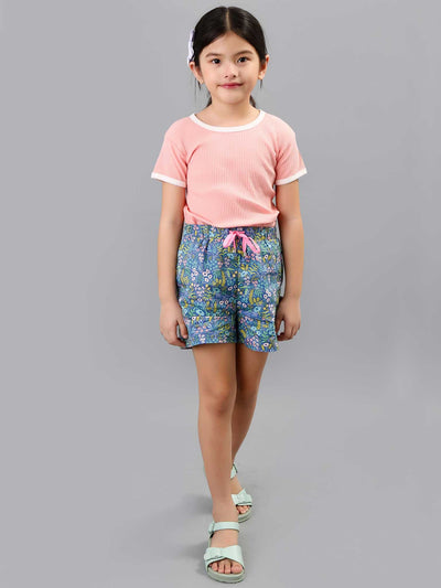 A little girl wearing Navy & Pink Flower Adele Blue Lotus shorts with generous leg openings.