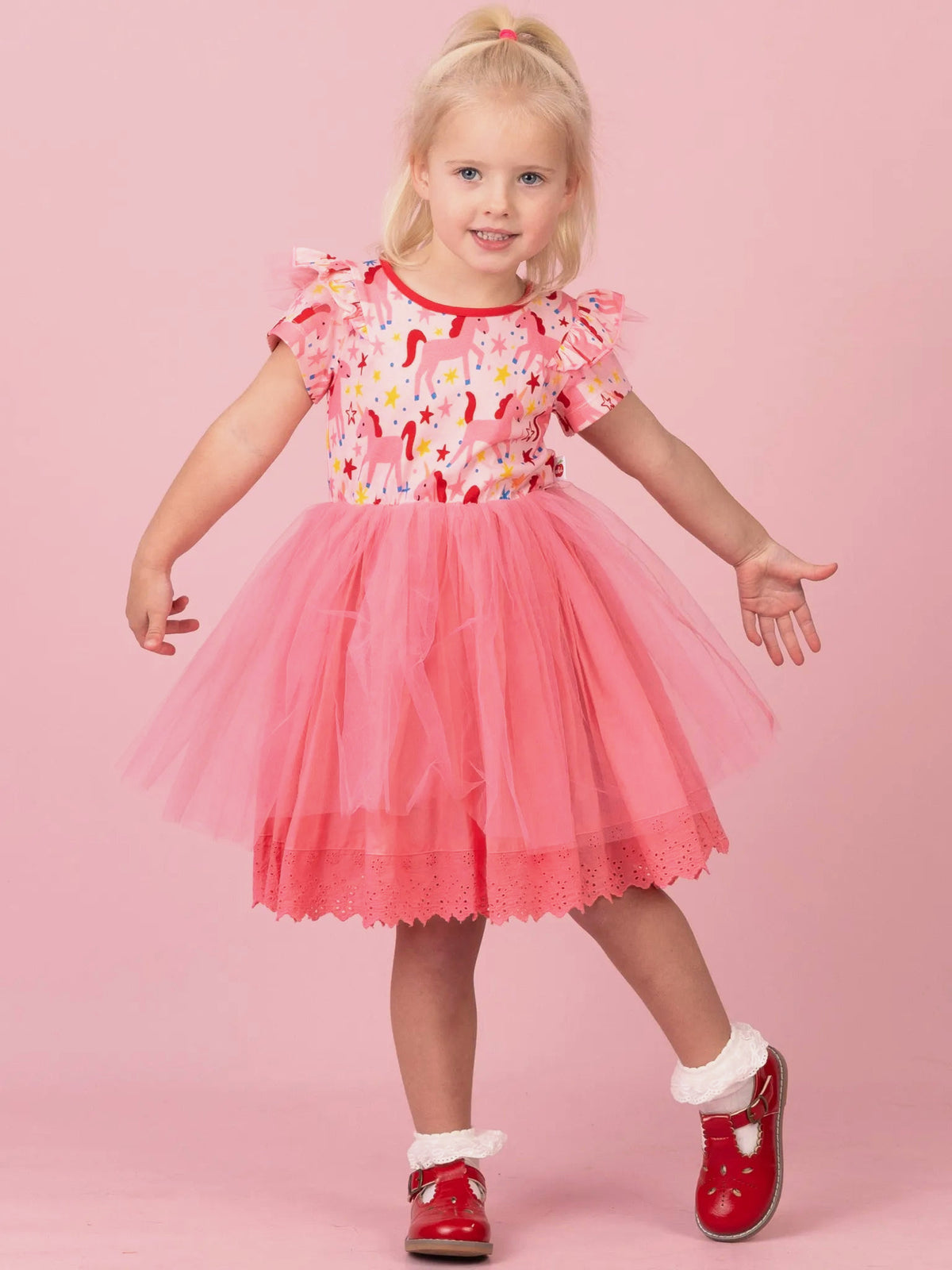 Girl in Magical Unicorn Claudia tutu dress with pink tulle skirt