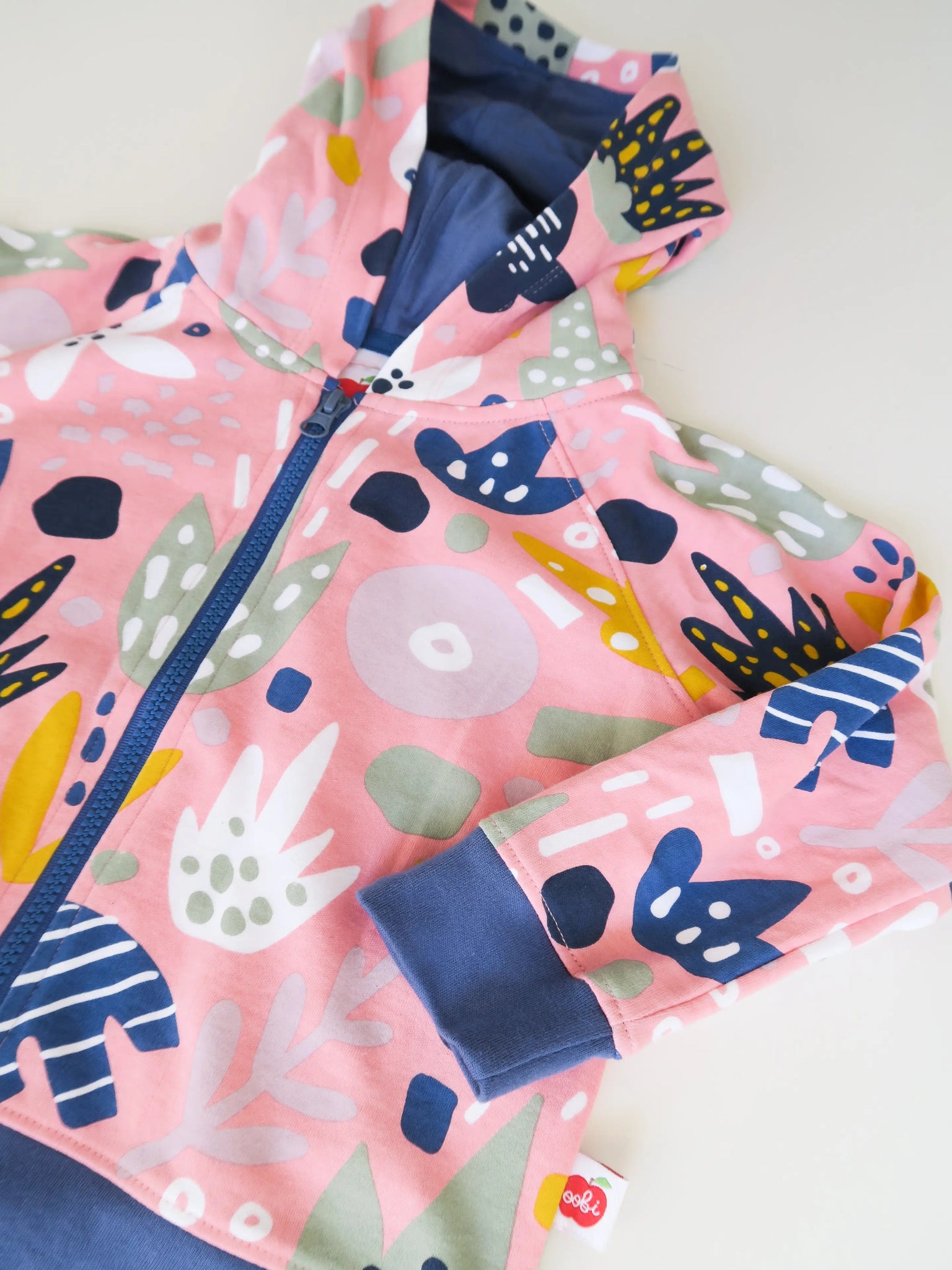 Children's jacket with colorful abstract pattern on a white background