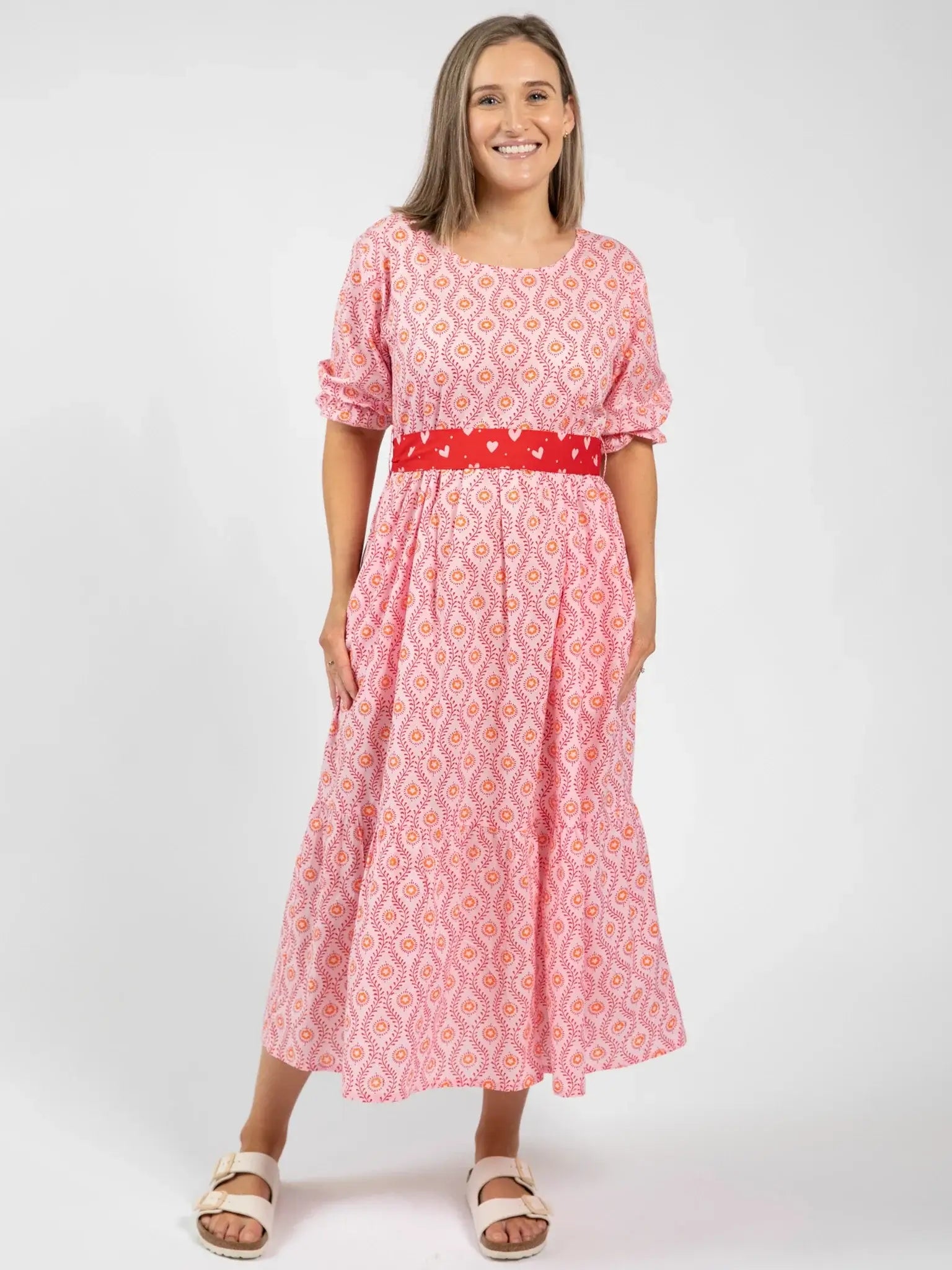 A woman in the Blue Stripe Women's Woodblock Maxi Dress stands against a plain white background, smiling.