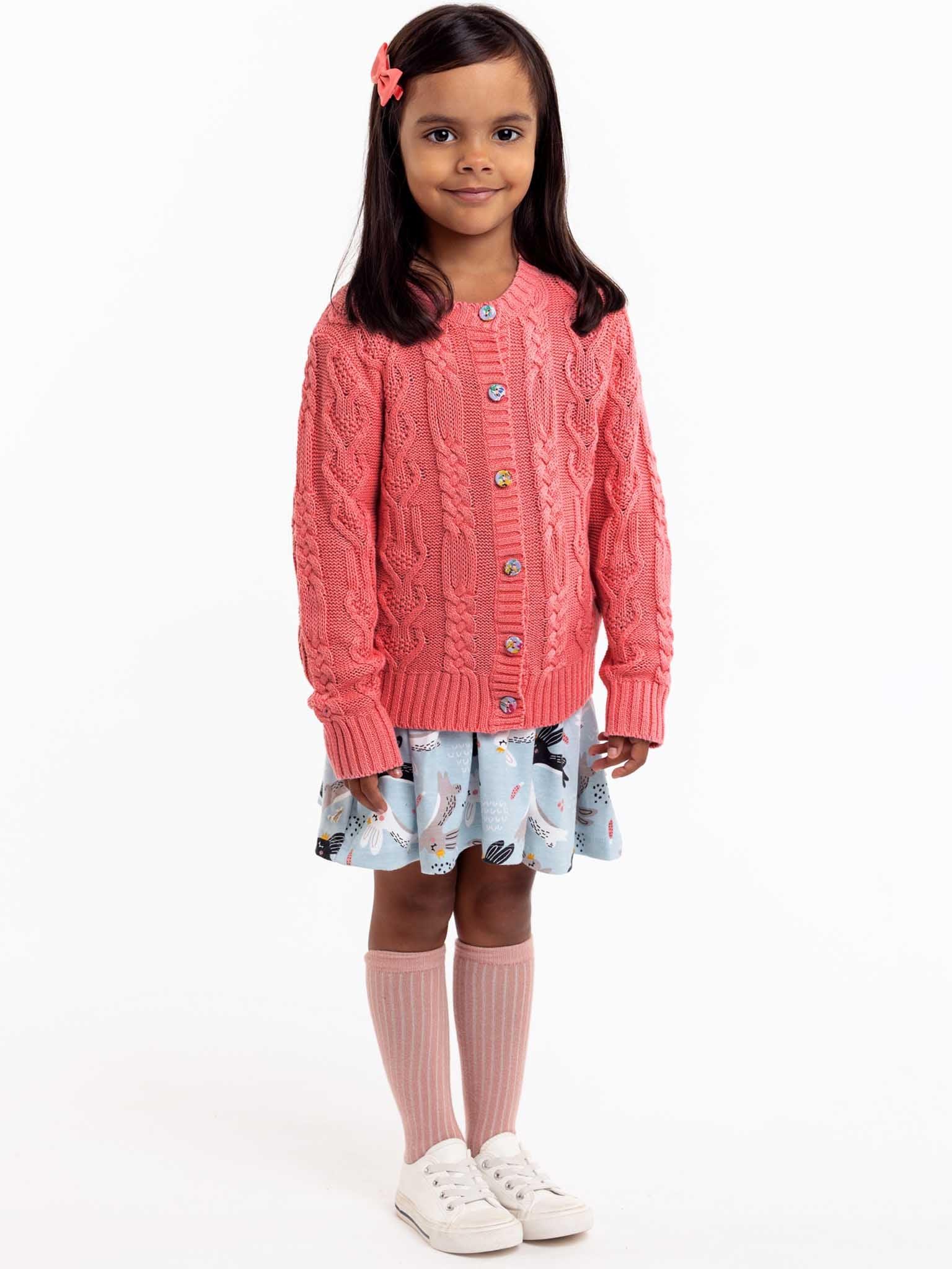 A little girl wearing a Willow Geranium Pink Cotton Cardigan by Knitwear.