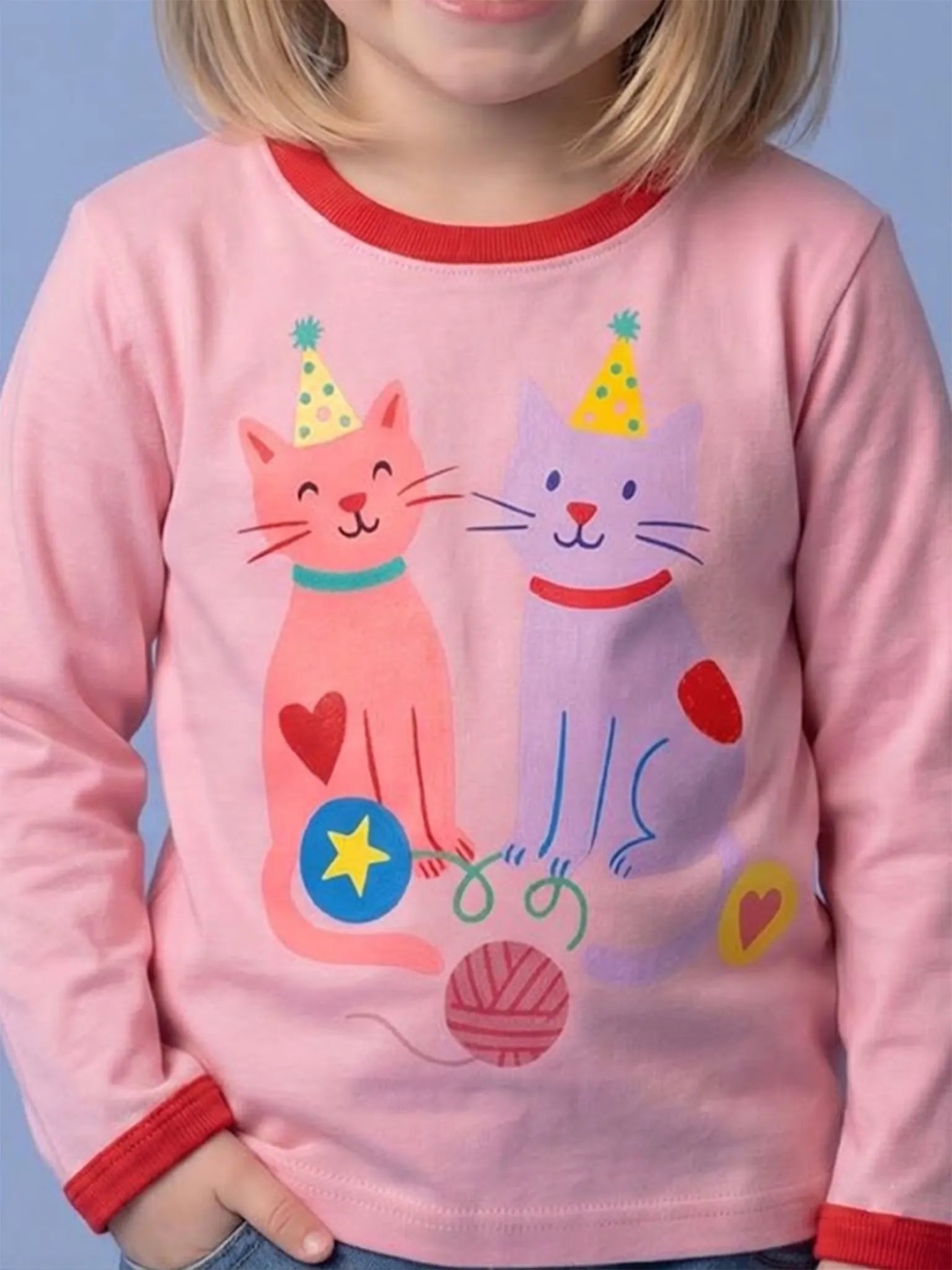 Pink children's long-sleeve shirt with cartoon cats design on a blue background