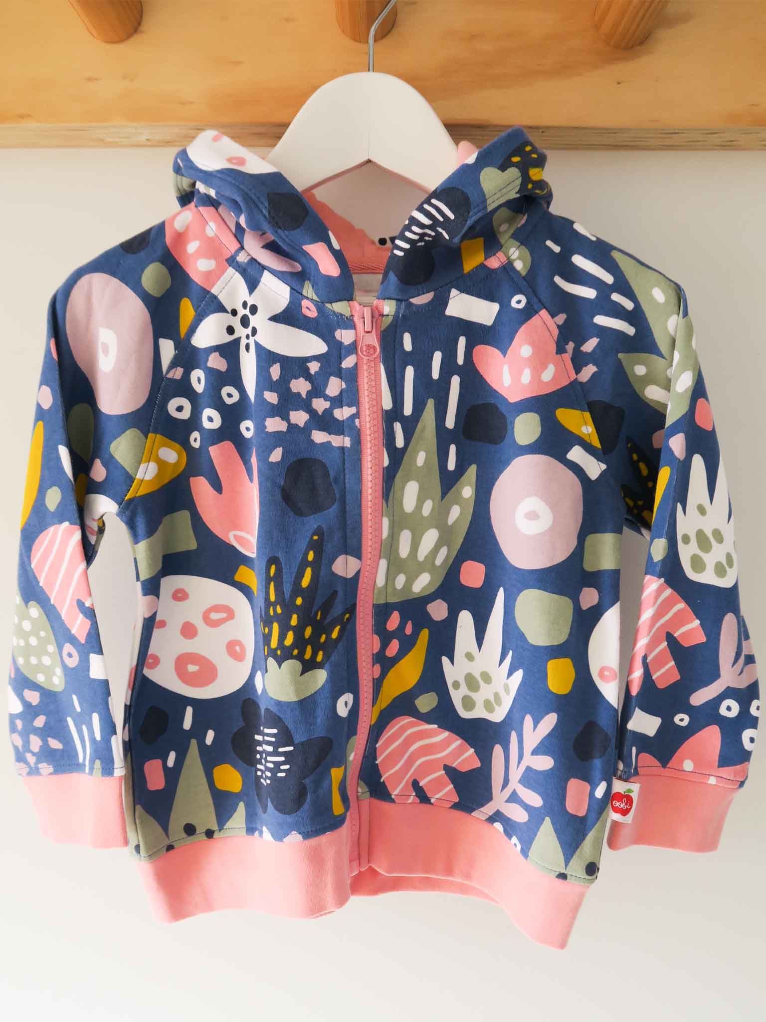 Colorful children's hoodie with abstract patterns on a white background