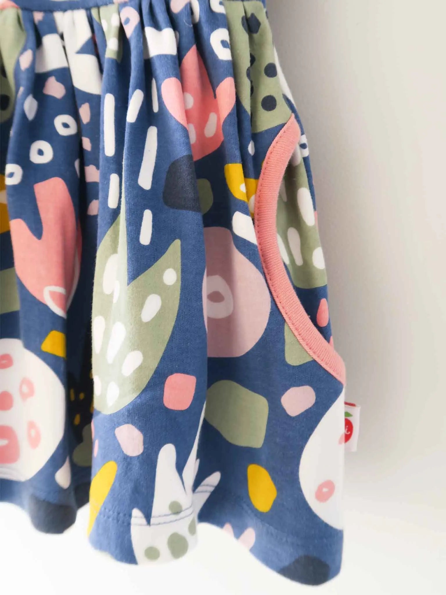 Close up details of navy jungle print dress