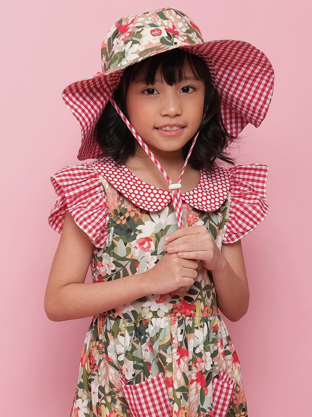 Girl in the floral Chloe sun hat with chin cord