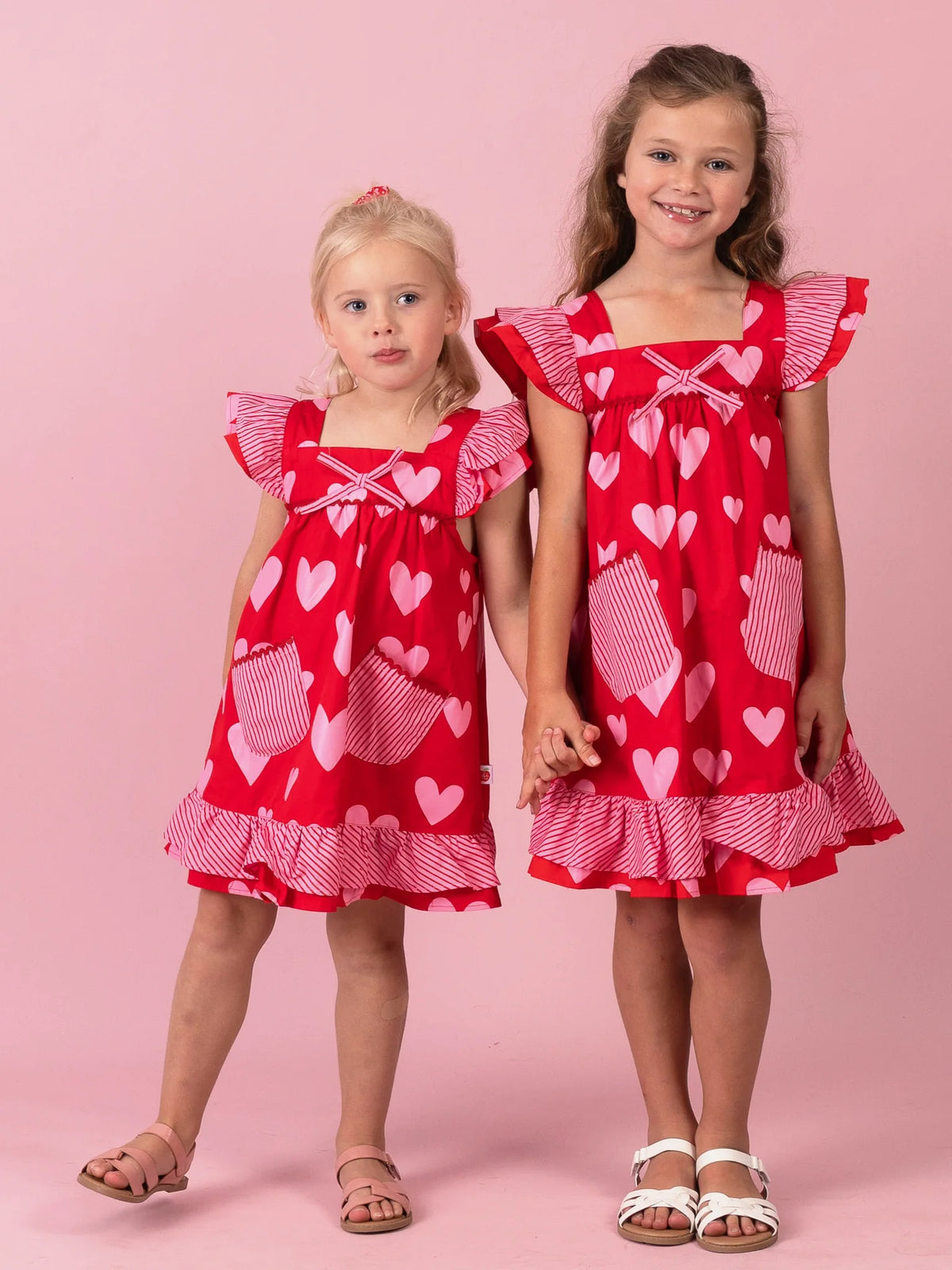 Sisters in matching Big Red Heart Holly dresses