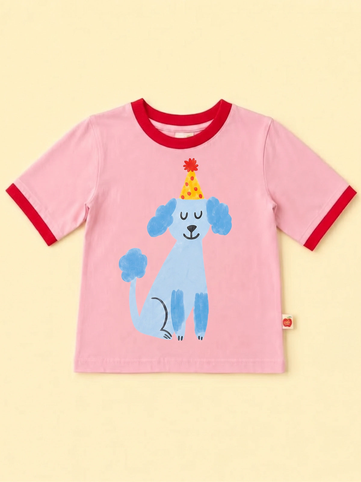 Pink tee with red binding featuring a blue poodle with a party hat