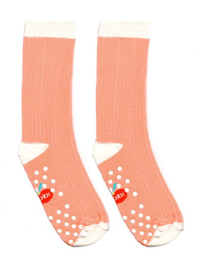A pair of Cheeky Pink Midi Scrunch Socks with polka dots on them from the brand Essentials.