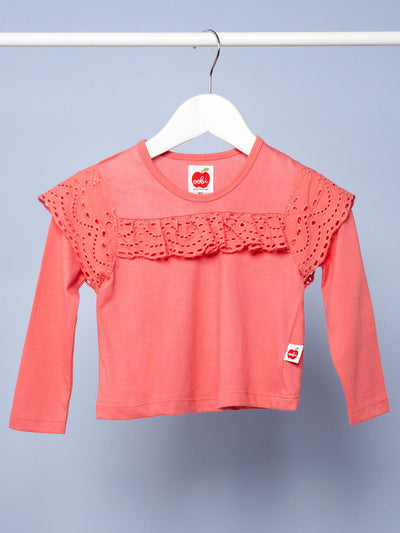 Imperfect Essentials lace front tee in warm pink on a white hanger against a blue background.