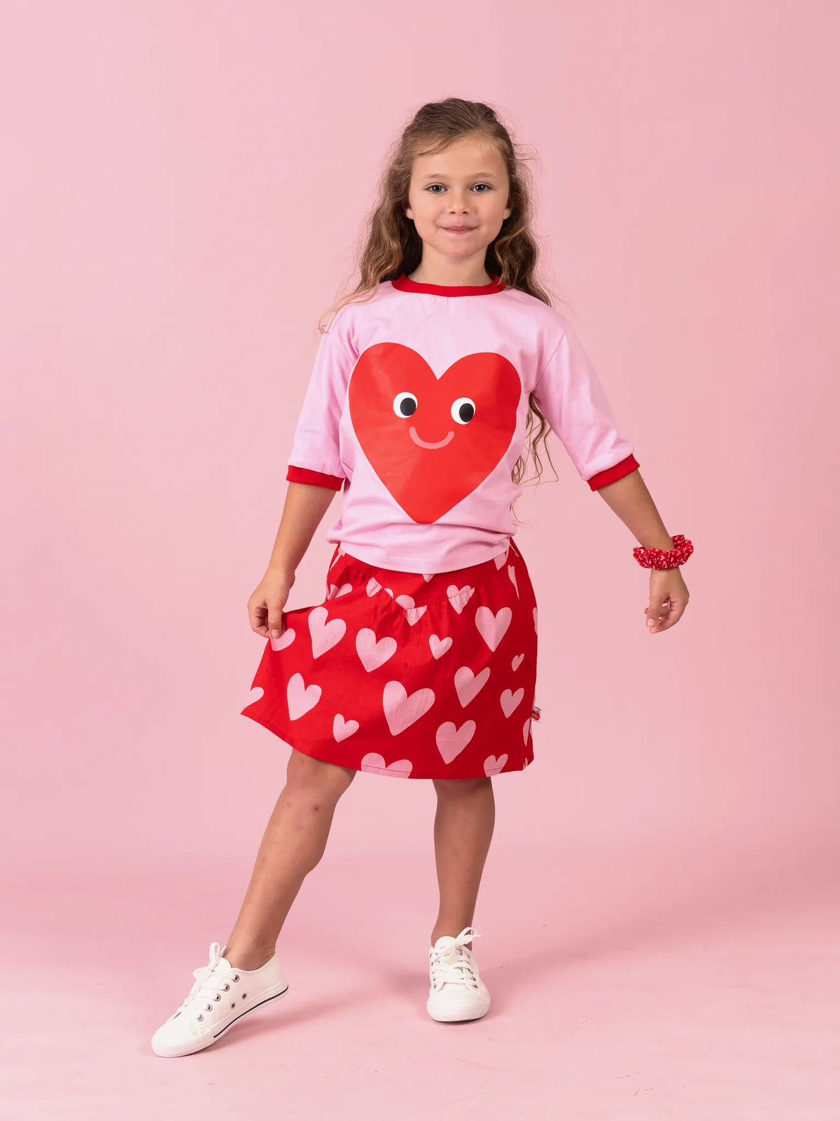 Girl in the pink Happy Heart tee and Big Red Heart yoke skirt