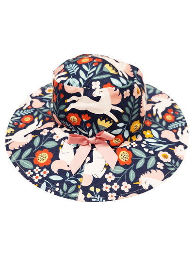 A Magic Unicorn Chloe Hat, a colorful floral print summer bucket hat with a decorative bow and ponytail hole.