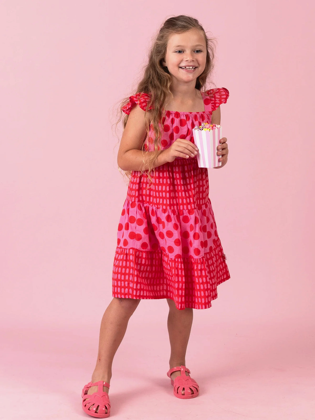 Girl in the Jaipur Block-Print Holiday dress with flutter sleeves