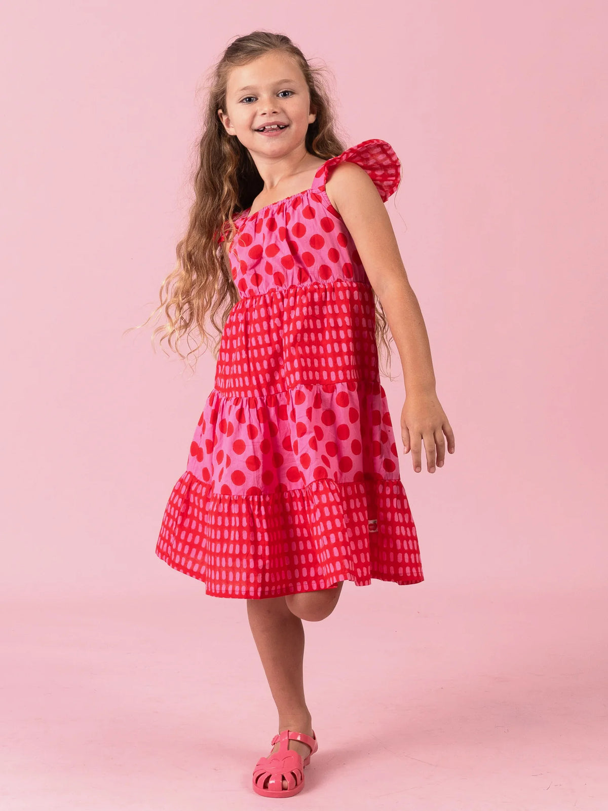 Girl in the Jaipur Block-Print Holiday dress with flutter sleeves