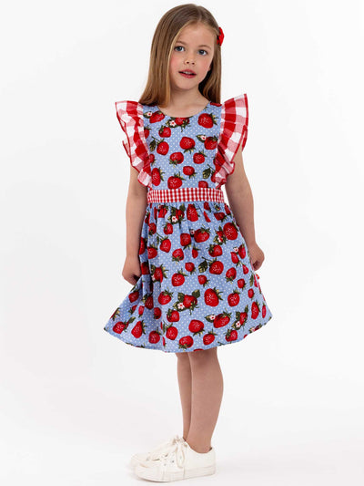 A little girl wearing a festive Strawberry Fields Jayne dress.