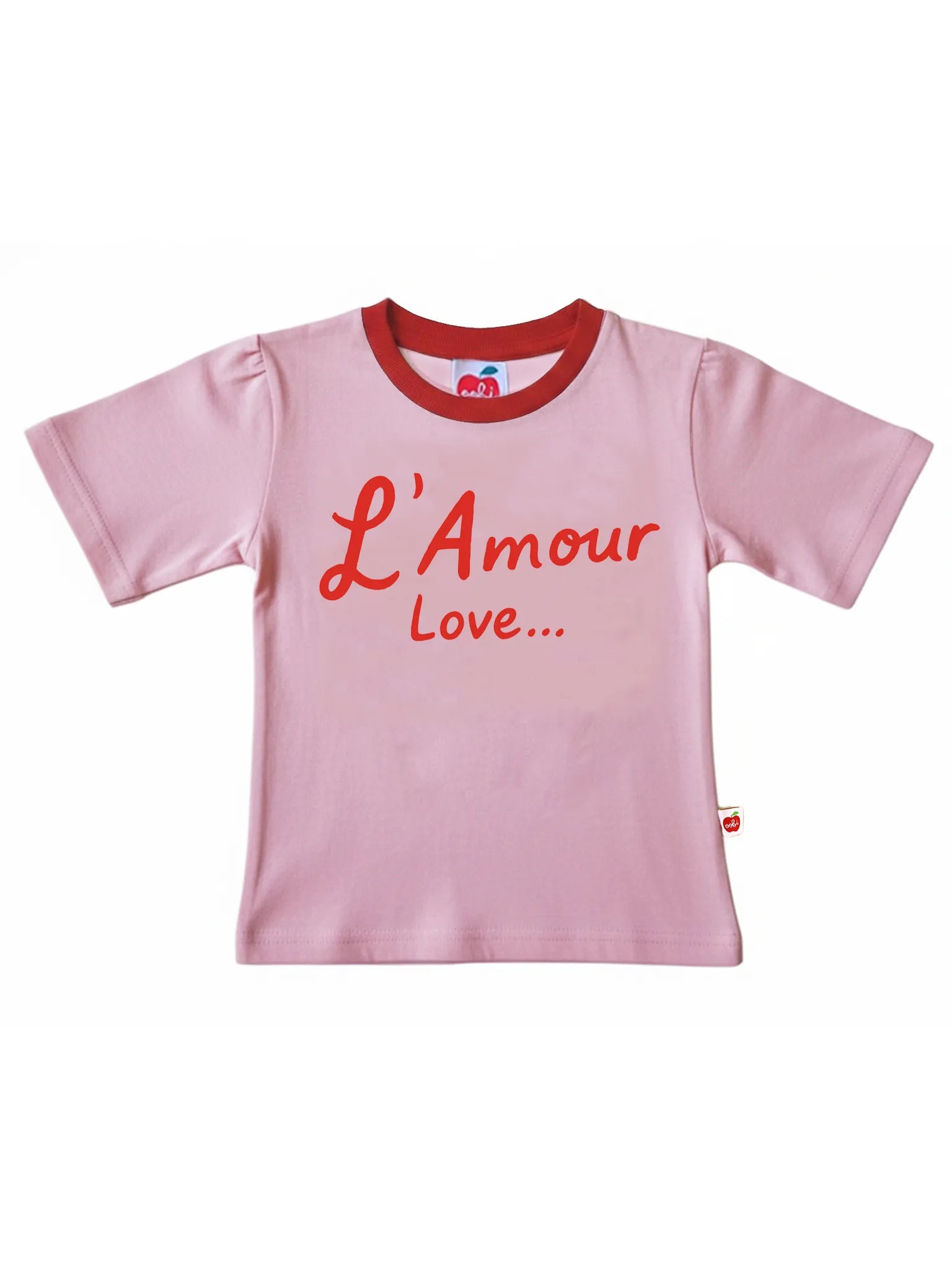 The Essentials L'Amour (Love) Tee with Red Binding is a pink short-sleeve 100% cotton shirt, featuring "L'Amour Love..." in red on the front—ideal for matching family outfits.