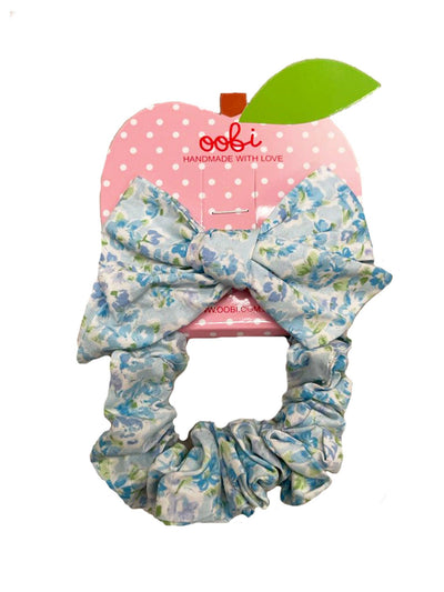 An Essentials Little Blue Hair Bow & Scrunchie Set with a hair bow tie and a flowery ribbon.