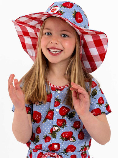 A little girl wearing a Strawberry Fields Chloe Hat.