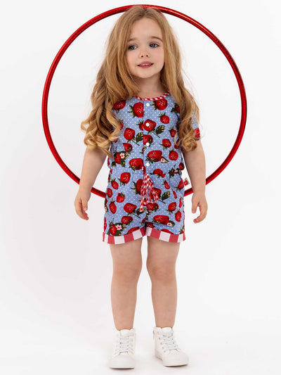A little girl wearing the Strawberry Fields Maisy Playsuit stands in a circle with a hula hoop.