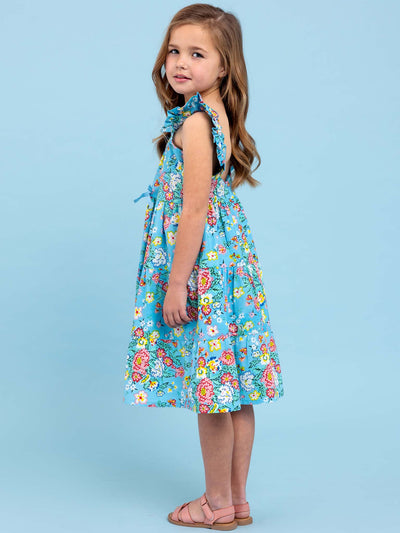 A little girl wearing a Cornflower Meadow Midi-Maxi Dress, a beloved print floral dress from Cornflower.