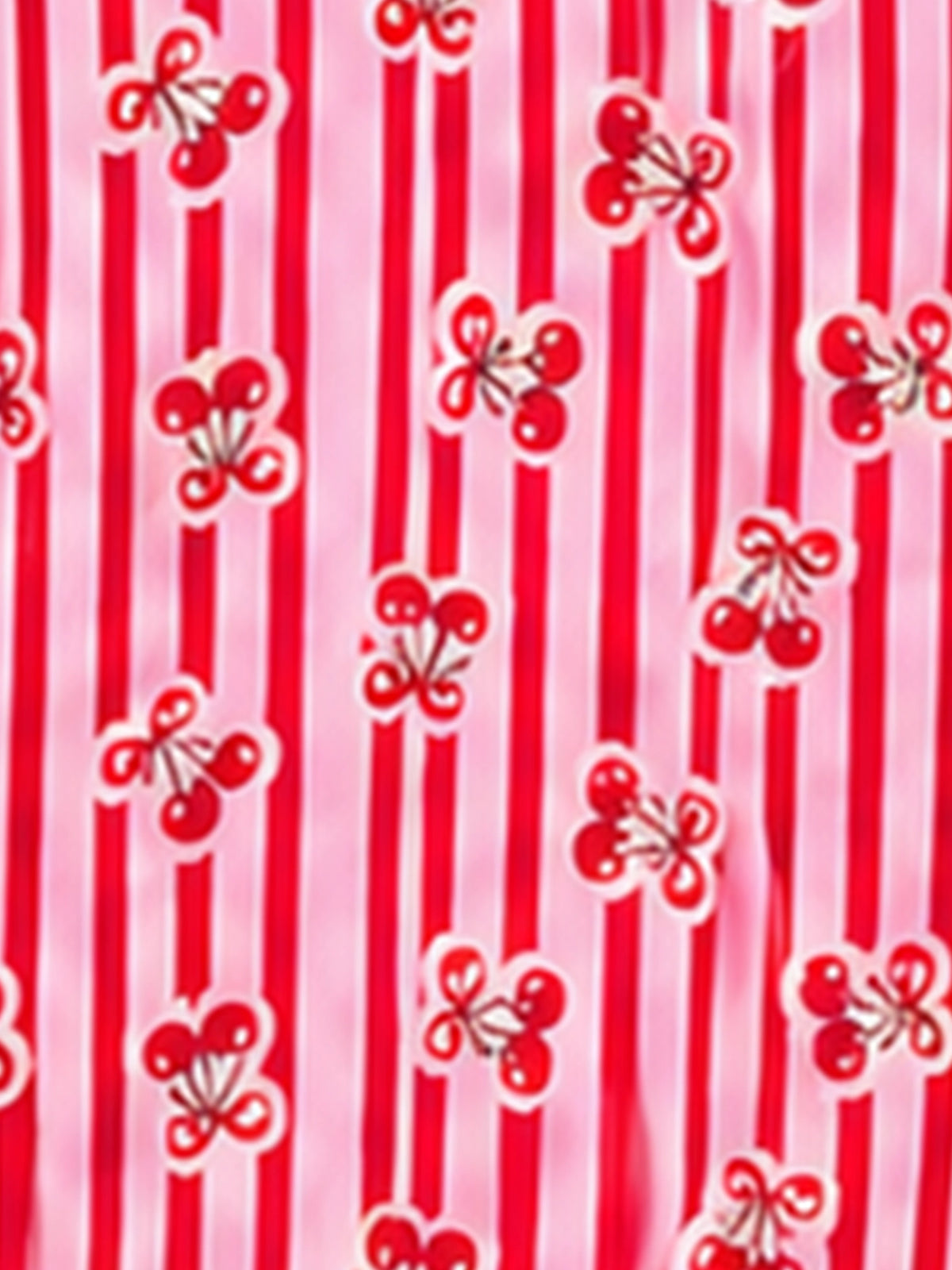 A close-up of a fabric pattern featuring vertical red and light pink stripes with small red cherry motifs outlined in white.