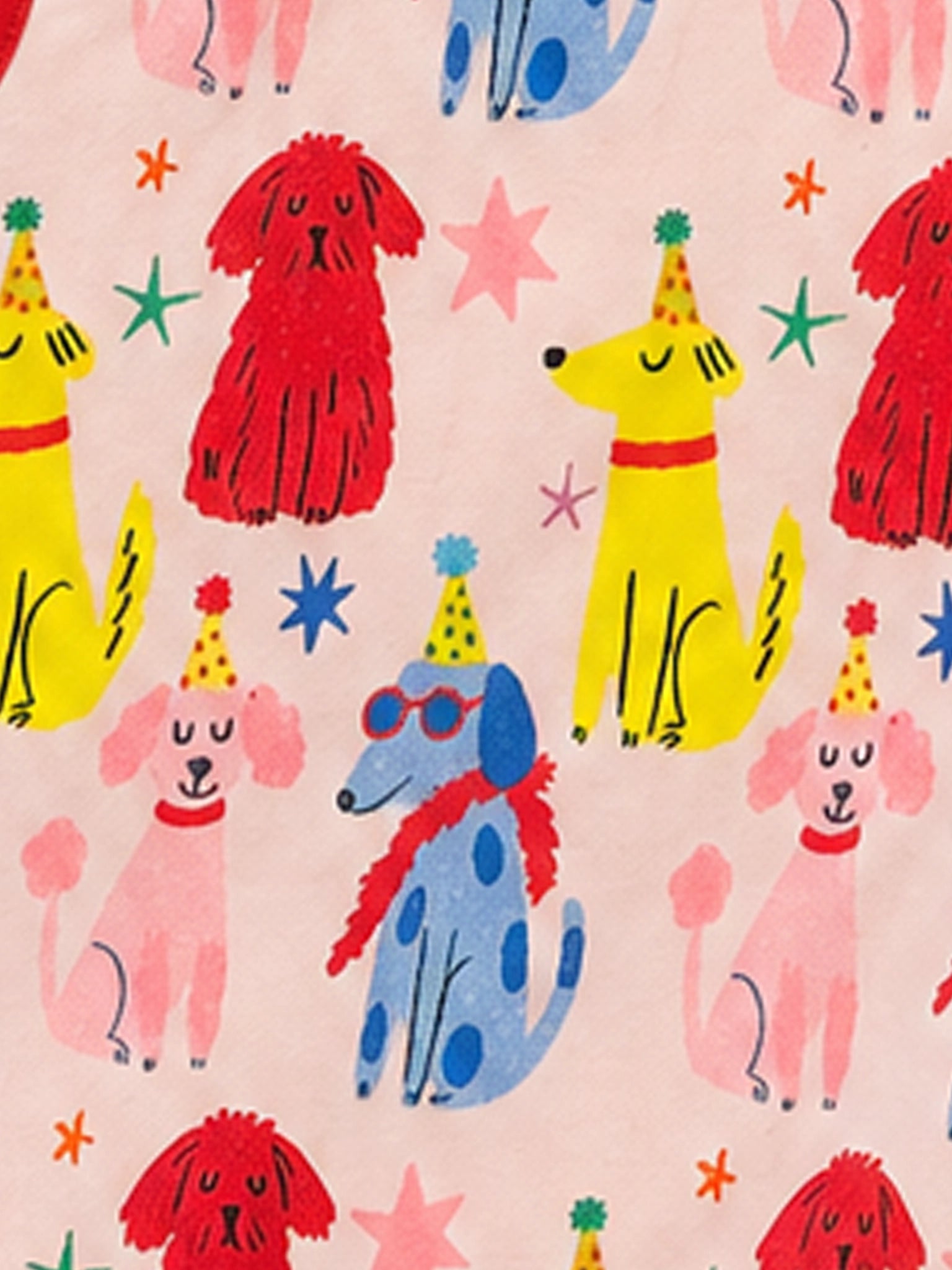 A close-up of a fabric pattern featuring playful cartoon dogs in red, yellow, pink, and blue, wearing party hats and sunglasses on a light pink background.