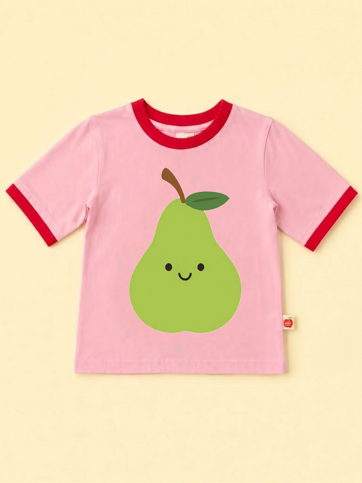 A pink ringer t-shirt with red trim on the collar and sleeve cuffs, featuring a cute green cartoon pear graphic on the front.