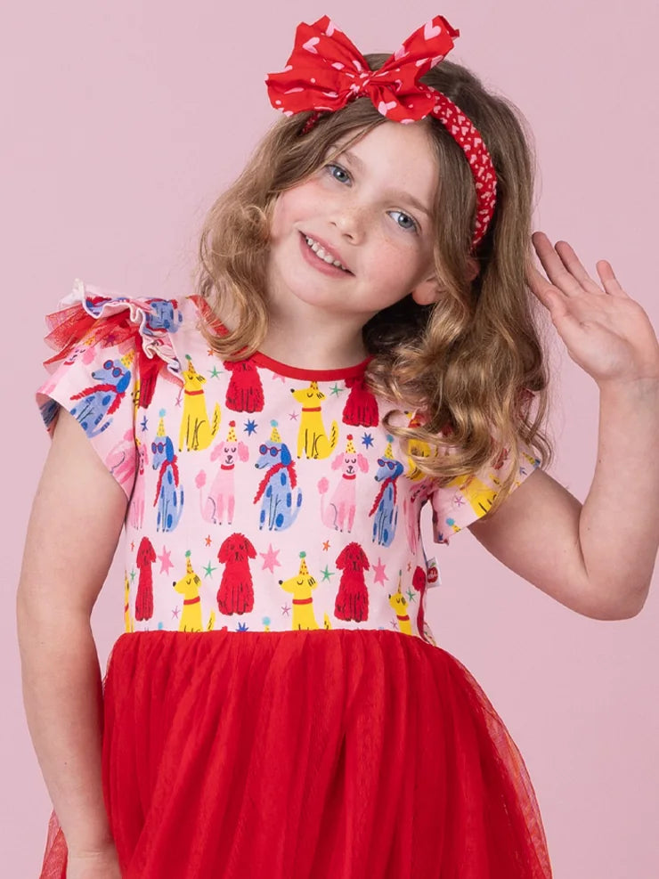 Girl wearing the Pink & Red Mini Hearts bow headband, an oversized red bow with tiny hearts