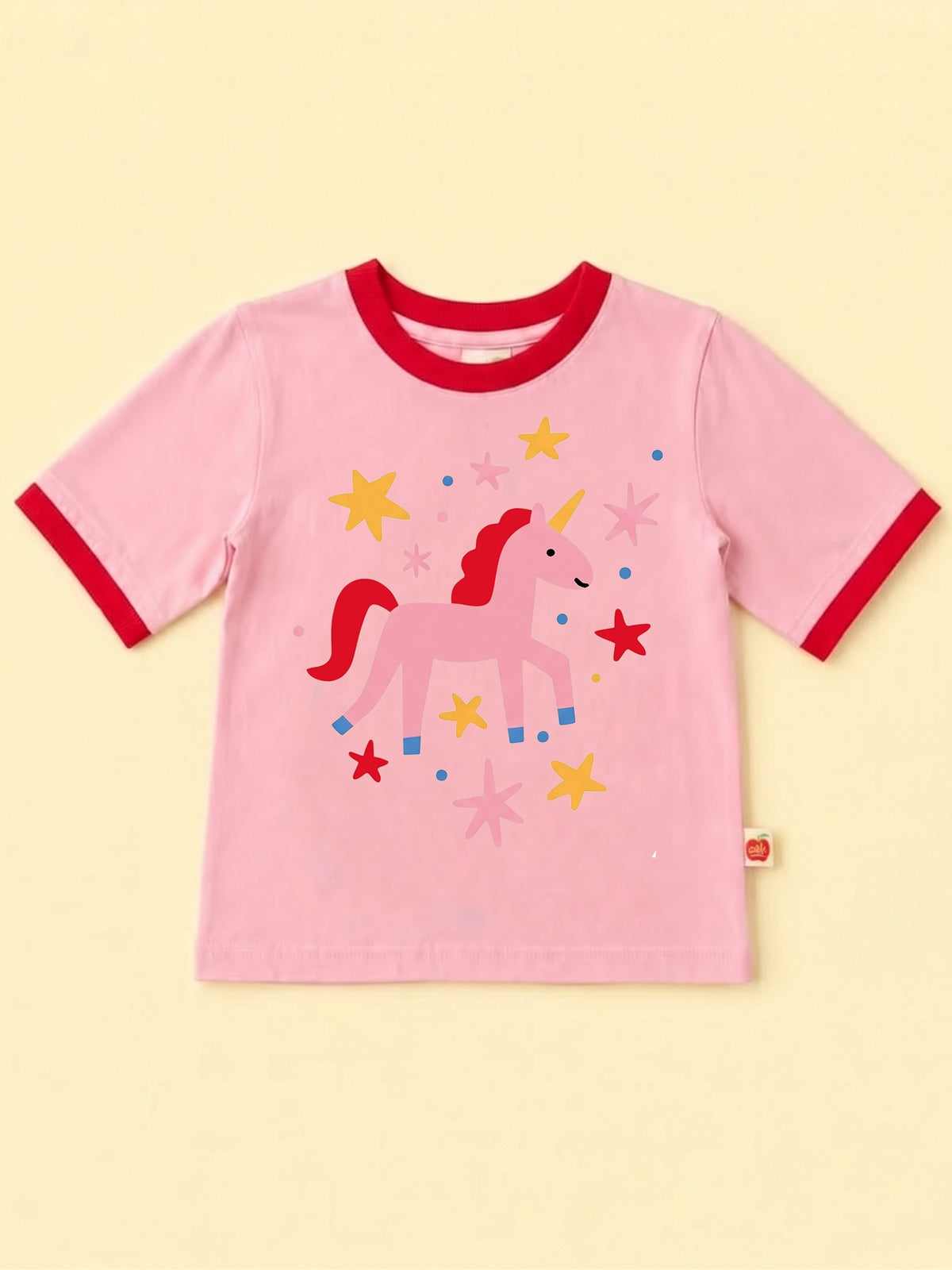 Pink tee with red binding with a colourful unicorn print with stars and dots