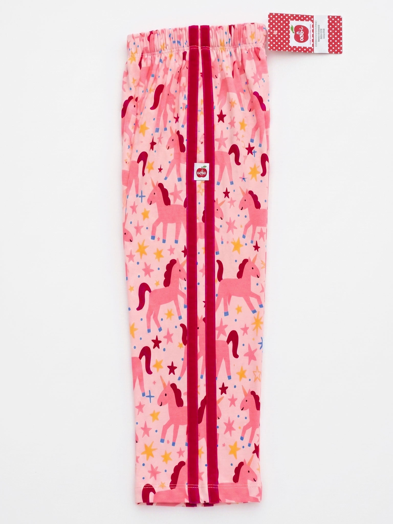 Pink children's leggings with a unicorn and star print, featuring a front zipper and an elastic waistband with a red and white patterned tag.