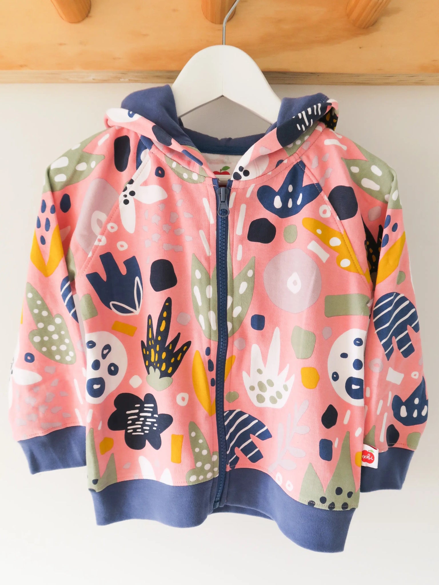 Colorful children's hoodie with abstract patterns on a white background