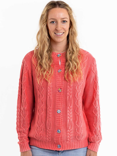 A woman wearing a women's Willow Geranium Pink Cardigan by Knitwear.