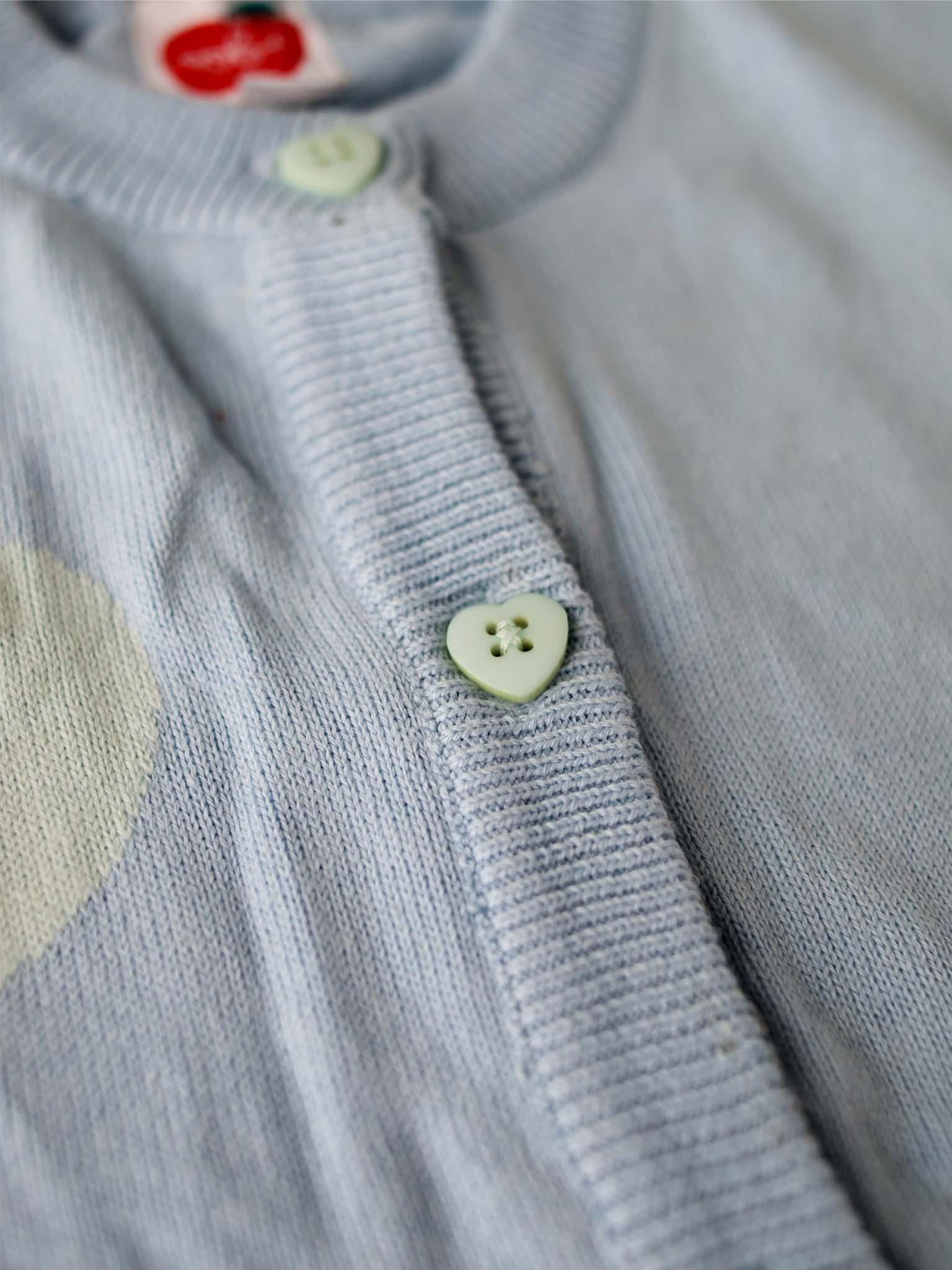 A close up of a Maxine Starlight Hearts Cotton Cardigan with heart-shaped buttons made by Knitwear.