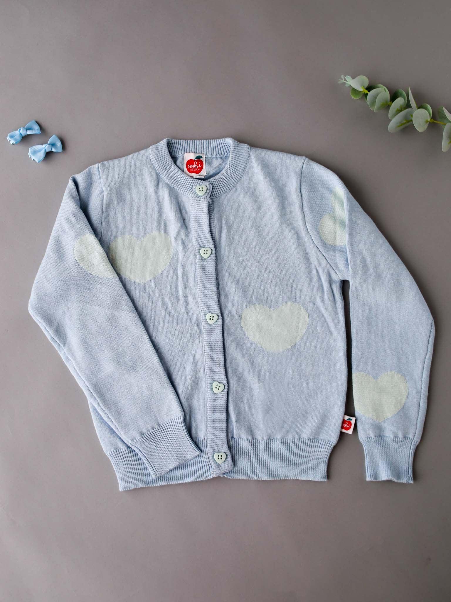 A Maxine Starlight Hearts Cotton Cardigan with white clouds by Knitwear.